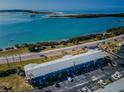 Beautiful aerial shot showcasing the stunning waterfront building next to the ocean and highway at 2 Causeway Blvd # 208, Dunedin, FL 34698
