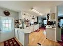 Bright kitchen with wooden floors, white cabinets, and modern appliances that create a cozy atmosphere at 205 Seagull N Dr, Tarpon Springs, FL 34689