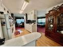 Open kitchen with wood floors offering seamless transition to dining area with a glimpse into living space at 205 Seagull N Dr, Tarpon Springs, FL 34689