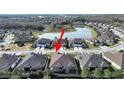 An aerial view highlights the home's position within a community with serene water features at 4375 Barletta Ct, Wesley Chapel, FL 33543