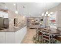 Open-concept kitchen featuring an island, stainless steel appliances, and seamless flow to the living area at 7185 N Serenoa Dr, Sarasota, FL 34241
