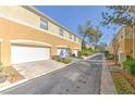 Exterior view of a row of townhome garages showing their clean, white doors and paved street access at 7570 Tamarind Ave, Tampa, FL 33625