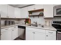 Well-lit kitchen featuring white cabinetry, stainless steel appliances, and granite countertops at 921 57Th N Ave, St Petersburg, FL 33703