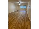 Bright living room featuring wood-look floors, a ceiling fan, and large windows at 11200 102Nd Ave # 125, Seminole, FL 33778
