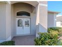 Close-up of a welcoming front entrance with a double door and brick-paved walkway at 12545 Leatherleaf Dr, Tampa, FL 33626