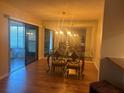 Inviting dining area with hardwood floors, sliding glass doors, and a large mirror accent at 2765 Countryside Blvd # 106, Clearwater, FL 33761