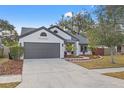 Charming one-story home with a beautifully landscaped front yard, fresh mulch, and healthy plants at 3038 Longbrooke Way, Clearwater, FL 33760