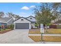 Charming one-story home with fresh landscaping, green grass, and a mailbox in the front yard at 3038 Longbrooke Way, Clearwater, FL 33760