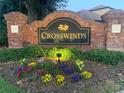 Welcome to Crosswinds, a beautiful community marked by a brick sign surrounded by colorful flowerbeds and greenery at 4446 Wildstar Cir, Wesley Chapel, FL 33544