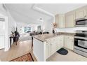 Open-concept kitchen featuring granite countertops and views into the living area at 4647 Lake Villa Dr, Clearwater, FL 33762