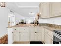 Kitchen with granite countertops and stainless steel sink overlooking the living area at 4647 Lake Villa Dr, Clearwater, FL 33762