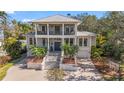 Stately two-story home featuring a metal roof, a brick driveway, and immaculate landscaping at 5010 W Dickens Ave, Tampa, FL 33629