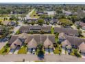 An aerial view shows a neighborhood with lush trees, townhomes, and neatly arranged residential streets at 6428 Thicket Trl, New Port Richey, FL 34653