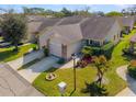 A sunny aerial view of a quaint residential neighborhood showcases well-kept lawns and attached garages at 6428 Thicket Trl, New Port Richey, FL 34653