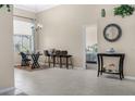 Bright dining room with tile floors, barstool seating, and a view into the bedroom at 7533 Dunbridge Dr, Odessa, FL 33556