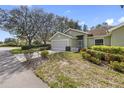 Well-manicured lawn and landscaping highlight this inviting one-story home with an attached two-car garage at 988 Villeroy Greens Dr, Sun City Center, FL 33573