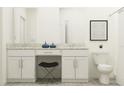 Bright bathroom showcasing double vanity with granite counters, stool, framed art, and toilet at 10807 Fort White Ct, Tampa, FL 33647