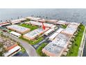 Aerial view of a condo community with lush lawns and assigned parking spots near the water at 19029 Us Highway 19 N # 35E, Clearwater, FL 33764