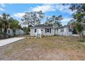 Gray home with tidy front yard, complemented by a freshly poured driveway at 1931 24Th S St, St Petersburg, FL 33712