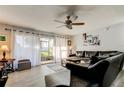 Comfortable living room with ceiling fan and sliding glass doors to the porch at 200 Country Club Dr # 503, Largo, FL 33771