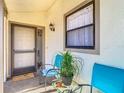 Inviting front porch with seating area and charming decor, bathed in soft sunlight, creating a welcoming entrance at 2606 Oak Cir, Tarpon Springs, FL 34689