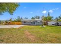 Well-maintained front yard of a cozy home with a lush lawn and mature trees at 3166 13Th N Ave, St Petersburg, FL 33713