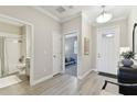 Bright entryway featuring tile floors, a bathroom to the left and an open view into a bedroom at 31675 Cannon Rush Dr, San Antonio, FL 33576