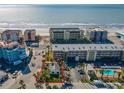 Aerial view of a beachfront property highlighting its proximity to the ocean and nearby residential buildings at 40 140Th E Ave, Madeira Beach, FL 33708