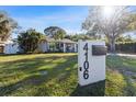 Well-manicured front yard with lush green grass and mature landscaping at 4106 W Bay View Ave, Tampa, FL 33611