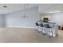 Bright, spacious living room with modern tile flooring, pendant lighting, and an open bar area at 5900 Bahia Del Mar Cir # 237, St Petersburg, FL 33715