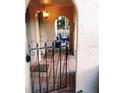 Arched entry to a tiled patio with an ornate gate leading to an outdoor seating area at 6262 142Nd Ave # 506, Clearwater, FL 33760
