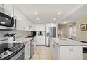 Bright kitchen features stainless steel appliances, ample storage, and modern fixtures at 9425 Blind Pass Rd # 507, St Pete Beach, FL 33706