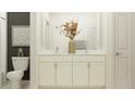 Elegant bathroom featuring double sinks, marble countertops, and a decorative flower arrangement at 9455 Runaway Breeze Dr, Land O Lakes, FL 34637