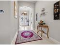 Bright foyer with arched doorways, tile flooring, and elegant decor at 13711 Moonstone Canyon Dr, Riverview, FL 33579
