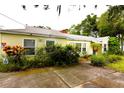 Cozy single-story home featuring a tidy front yard and blue front door at 1372 Palmetto St, Clearwater, FL 33755