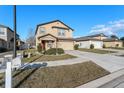 Charming two-story home with a well-manicured lawn, a two-car garage, and a mailbox with the house number at 14269 Lemon Yellow Tree Ln, Brooksville, FL 34613
