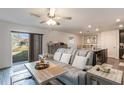 Comfortable living room with a sofa, view to the backyard, and open to the kitchen, ideal for entertaining at 14269 Lemon Yellow Tree Ln, Brooksville, FL 34613