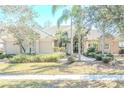 Elegant home exterior showcasing a tile roof, landscaped yard and double doors at 16331 Burniston Dr, Tampa, FL 33647
