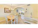 Bright dining room with seating for four flowing into the living room at 19417 Gulf Blvd # D-206, Indian Shores, FL 33785