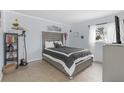 Neutral main bedroom featuring a large window for natural light and modern finishes at 245 Faithway Dr, Seffner, FL 33584