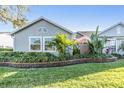 Well-maintained single-story home with lush landscaping and a beautiful stone retaining wall at 2473 Bentley Dr, Palm Harbor, FL 34684