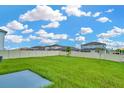 Expansive backyard features lush green grass, a privacy fence, and plenty of space for outdoor activities at 31818 Treasure Dock Isle, Wesley Chapel, FL 33545