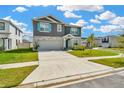 Charming two-story home with a two-car garage, stone veneer, and a well-manicured lawn on a sunny day at 31818 Treasure Dock Isle, Wesley Chapel, FL 33545