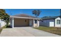 Cozy single-story home featuring a covered carport and a freshly paved driveway at 4017 W Nassau St, Tampa, FL 33607