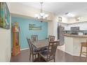 Open dining area with dark wood floors, adjacent to the kitchen, creating a cohesive living space at 4106 Central Sarasota Pkwy # 1023, Sarasota, FL 34238