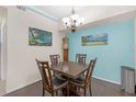 Bright dining area featuring a dark wood table, blue accent wall, and stylish light fixture at 4106 Central Sarasota Pkwy # 1023, Sarasota, FL 34238