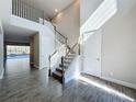 Elegant foyer with staircase, tile floors, and natural light at 4132 Woods Rider Loop, Odessa, FL 33556