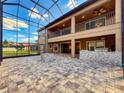 Spacious screened in patio with outdoor grill and two-story view of backyard at 4132 Woods Rider Loop, Odessa, FL 33556