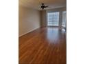 Bright living room featuring hardwood floors, a ceiling fan, and large windows at 5100 Burchette Rd # 2103, Tampa, FL 33647