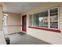 Inviting front porch with a red door and large windows offering ample natural light at 628 30Th N Ave, St Petersburg, FL 33704